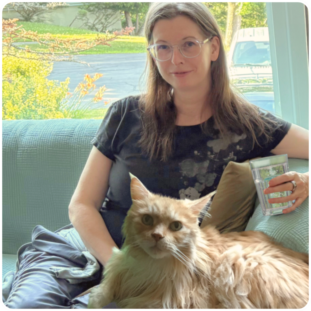 Carrie and Leo carrie profenno with maine coon cat on lap.