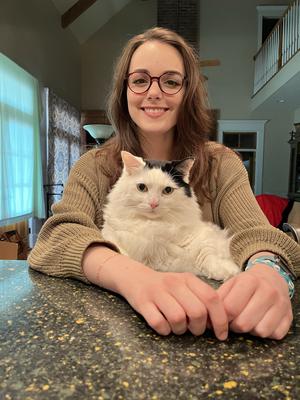 black van cat with woman sitting at a table